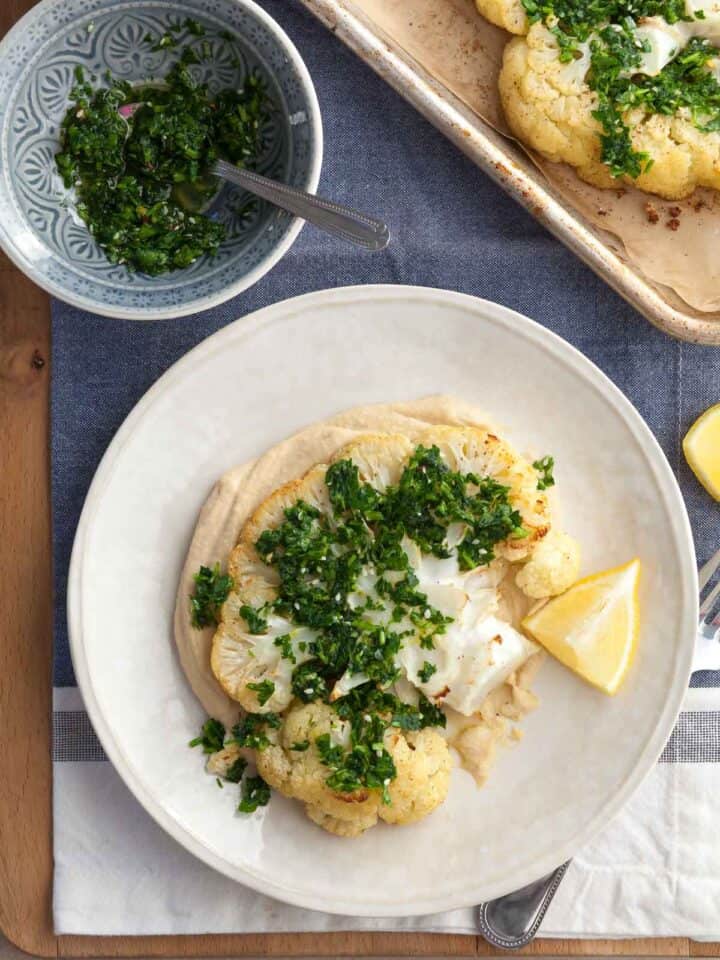 Vegan Cauliflower Steaks with Whipped Hummus & Fresh Gremolata on Plate