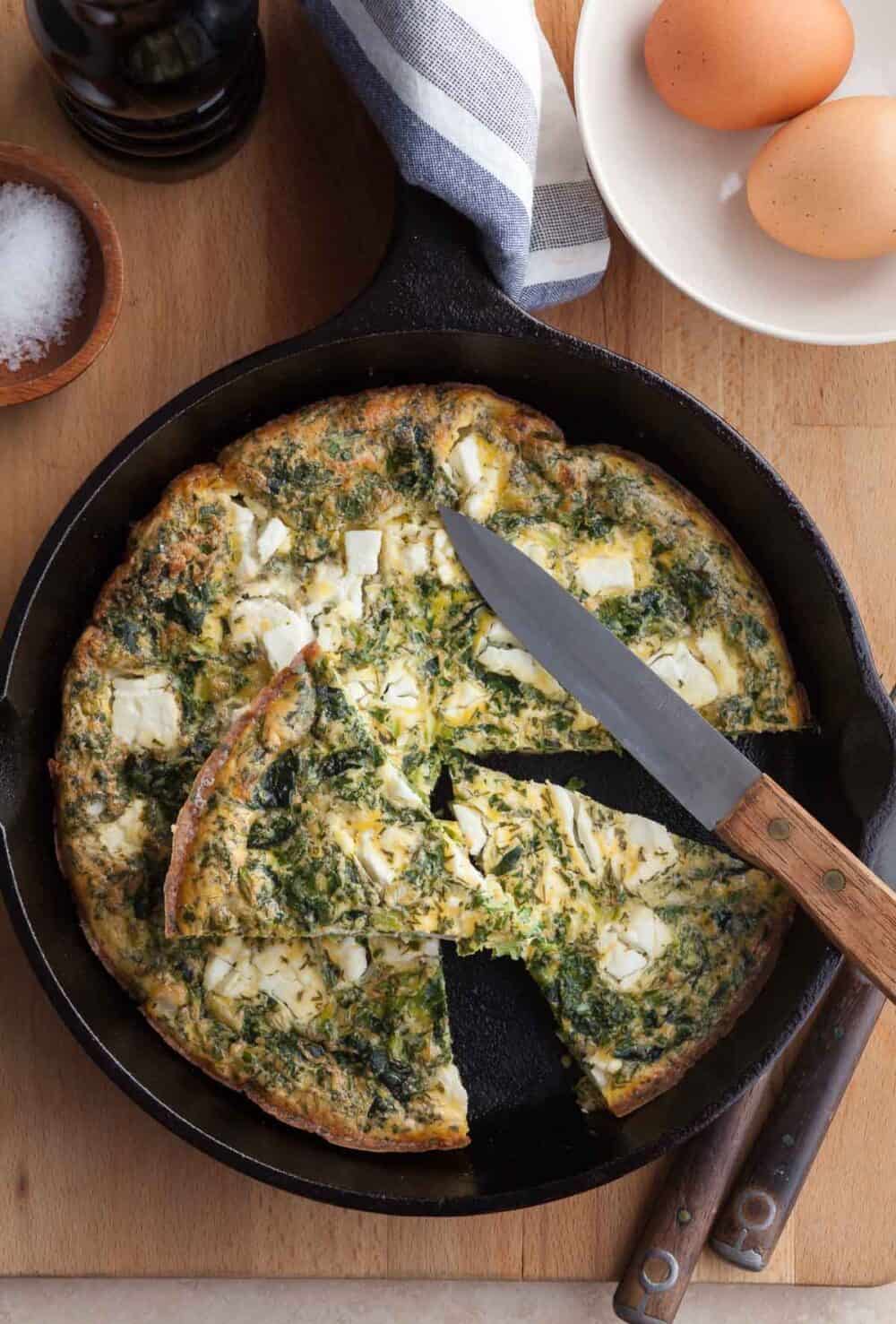 feta frittata in pan cut into slices