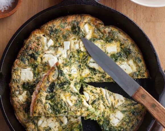 feta frittata in pan cut into slices