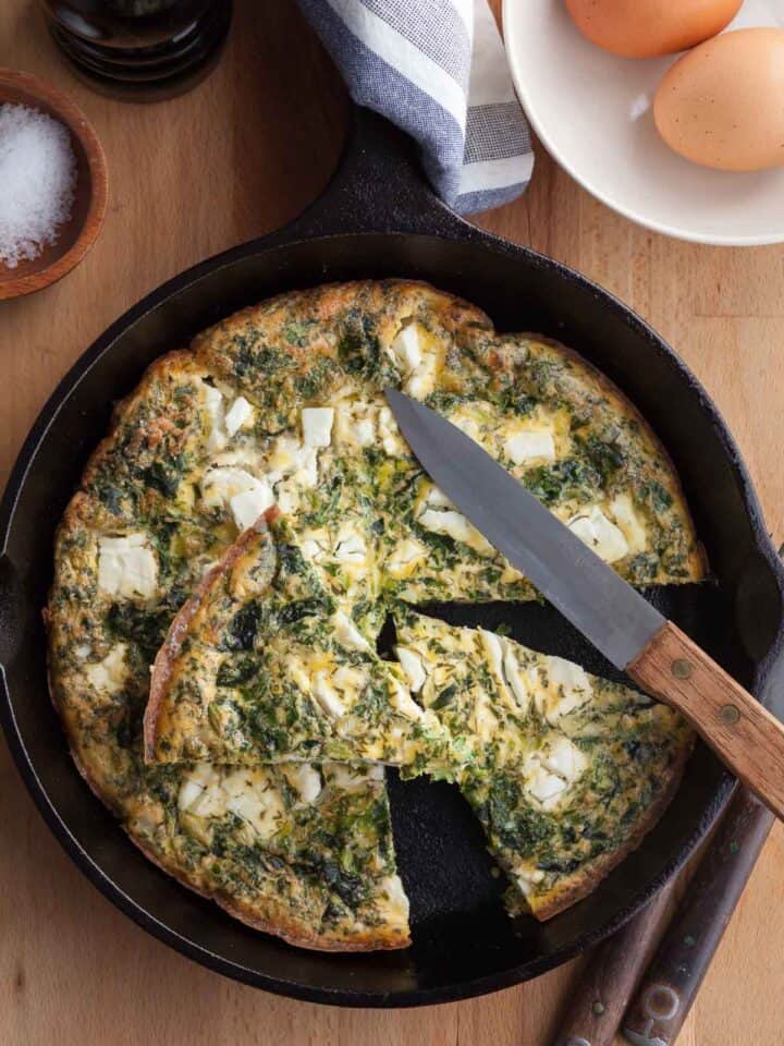 feta frittata in pan cut into slices