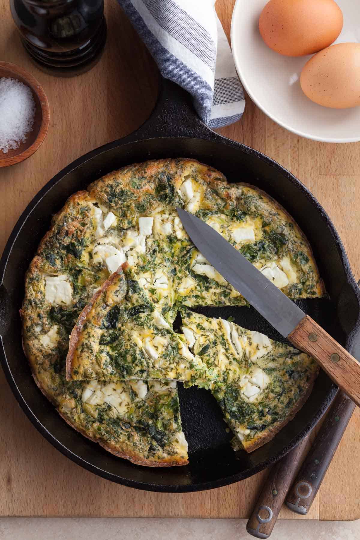 feta frittata in pan cut into slices