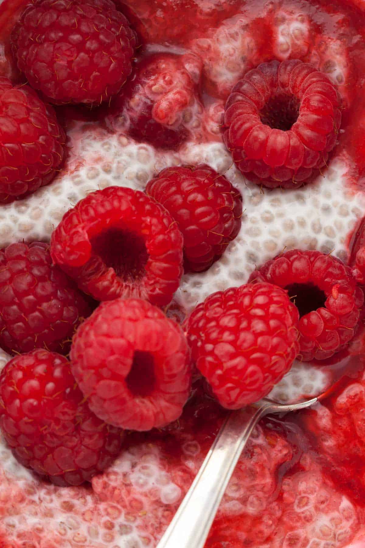 Raspberry Chia Seed Pudding close up on spoon