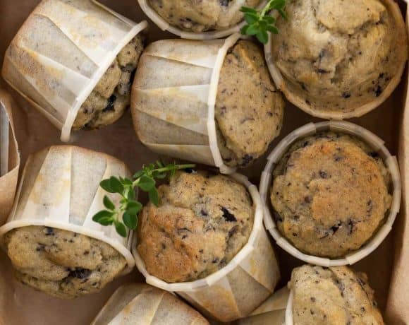 Savory gluten-free muffins made with feta, olives, and herbs in storage box.