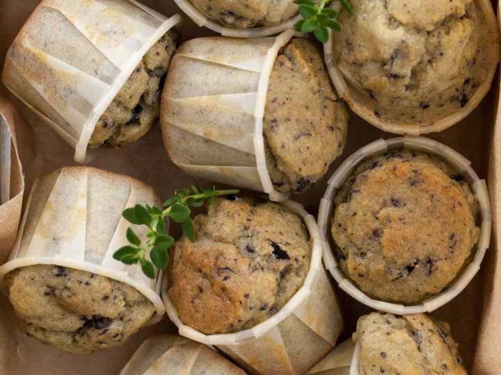 Savory gluten-free muffins made with feta, olives, and herbs in storage box.
