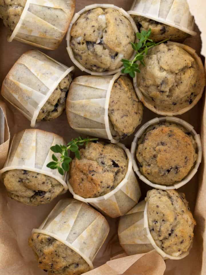 Savory gluten-free muffins made with feta, olives, and herbs in storage box.