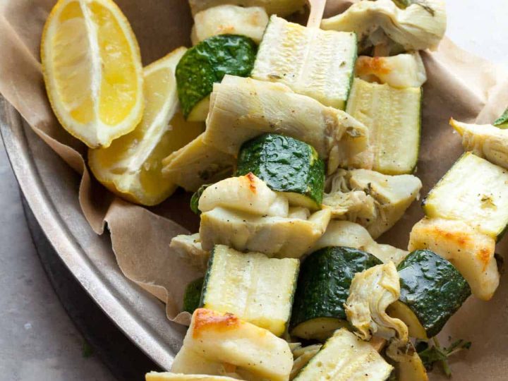 Grilled halloumi and vegetable skewers with lemon olive sauce in platter