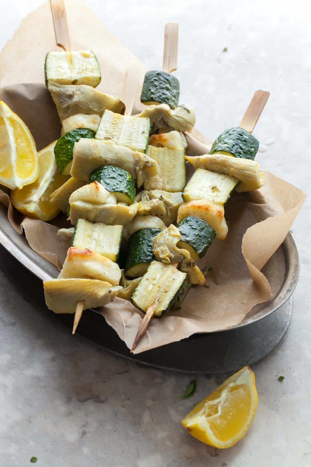 Finished halloumi vegetable skewers on serving platter for summer meal