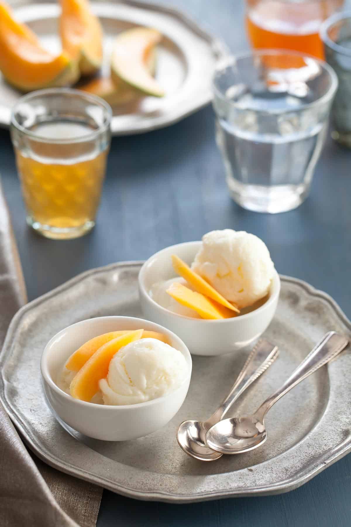 Honey frozen yogurt served with white tea-infused cantaloupe for a summer dessert