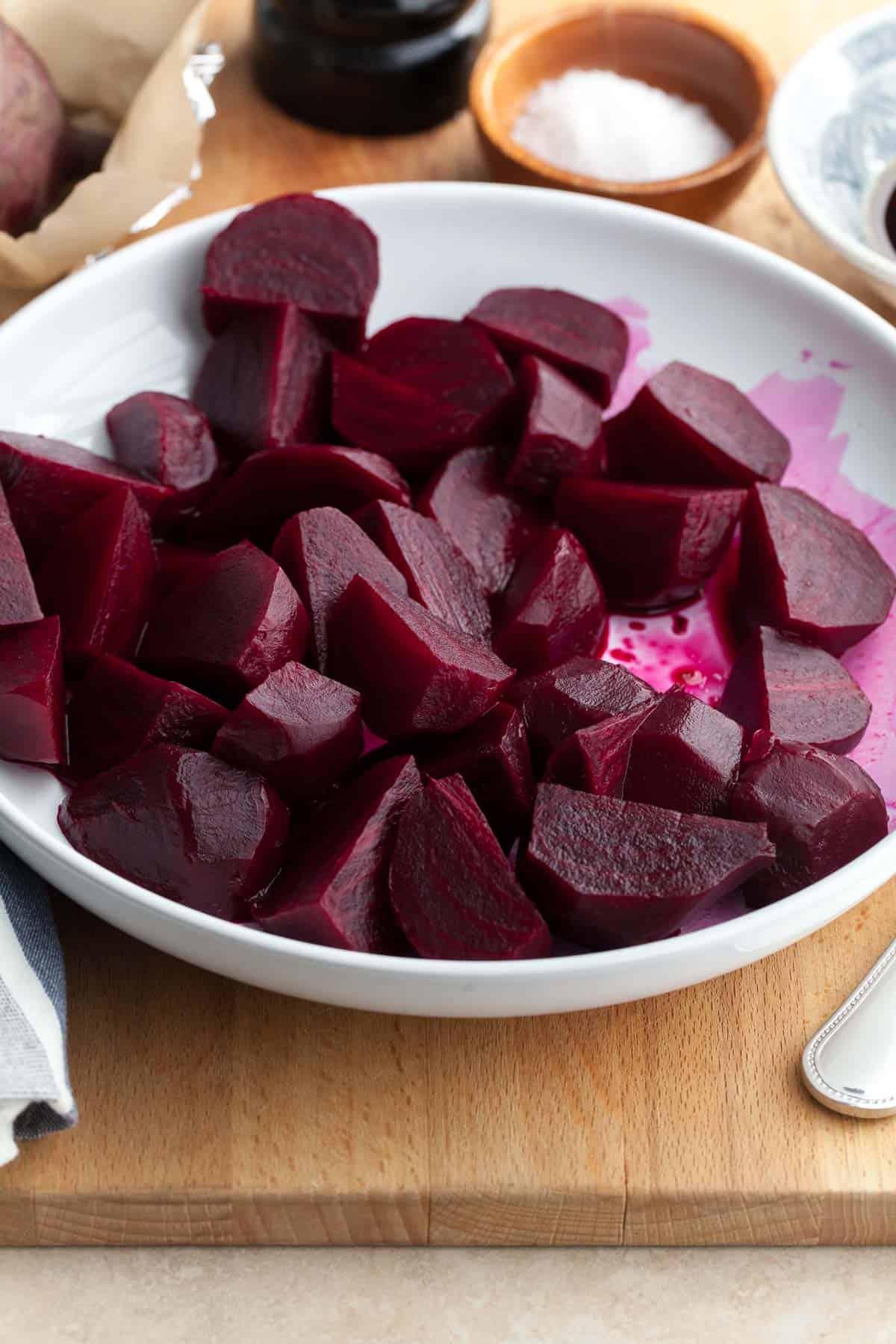 Roasted beets tossed in a simple vinegar marinade in bowl