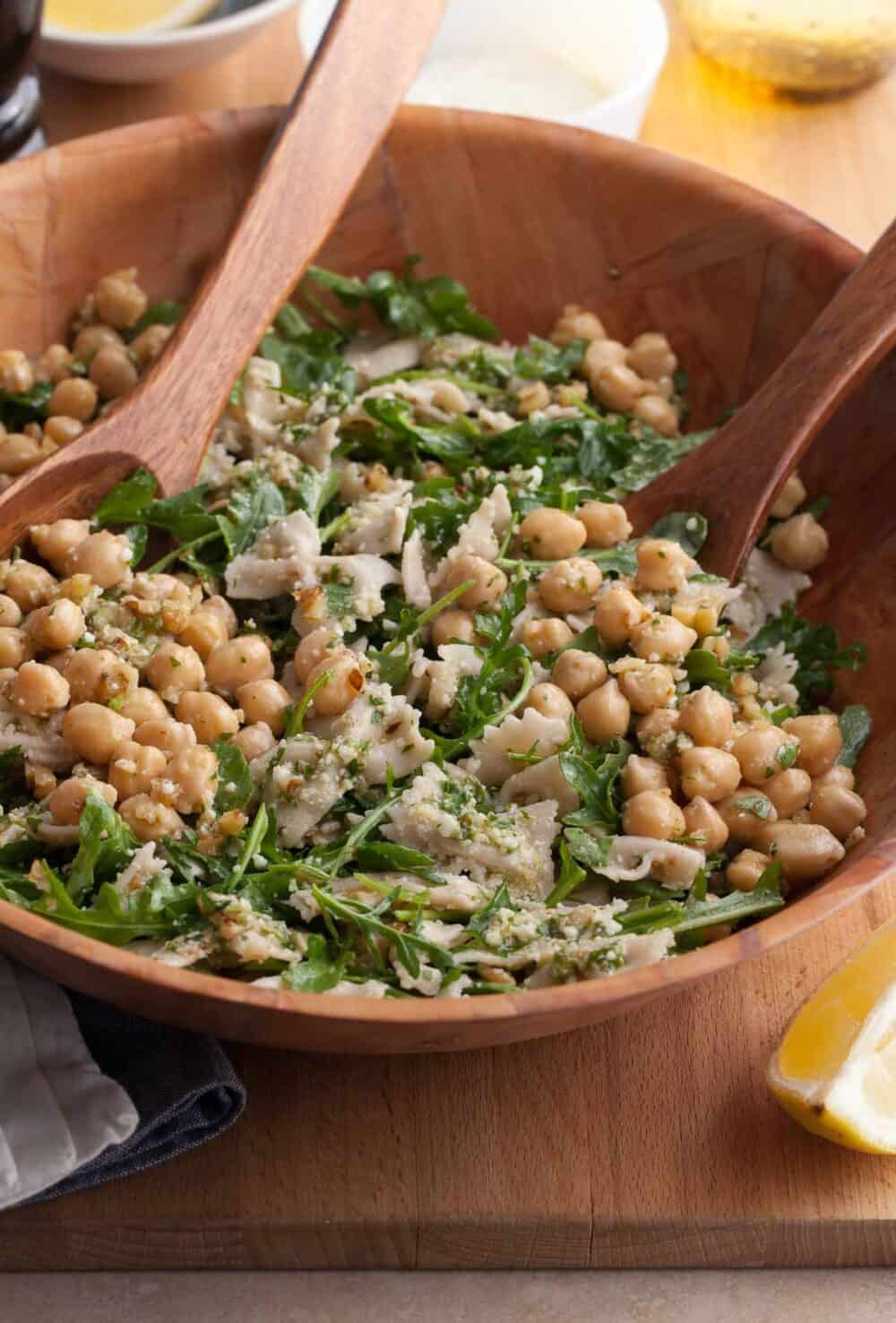 bright, easy pasta salad with chickpeas, arugula, and a lemon dressing in bowl