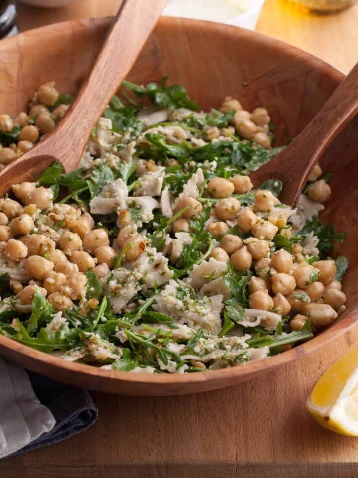 bright, easy pasta salad with chickpeas, arugula, and a lemon dressing in bowl