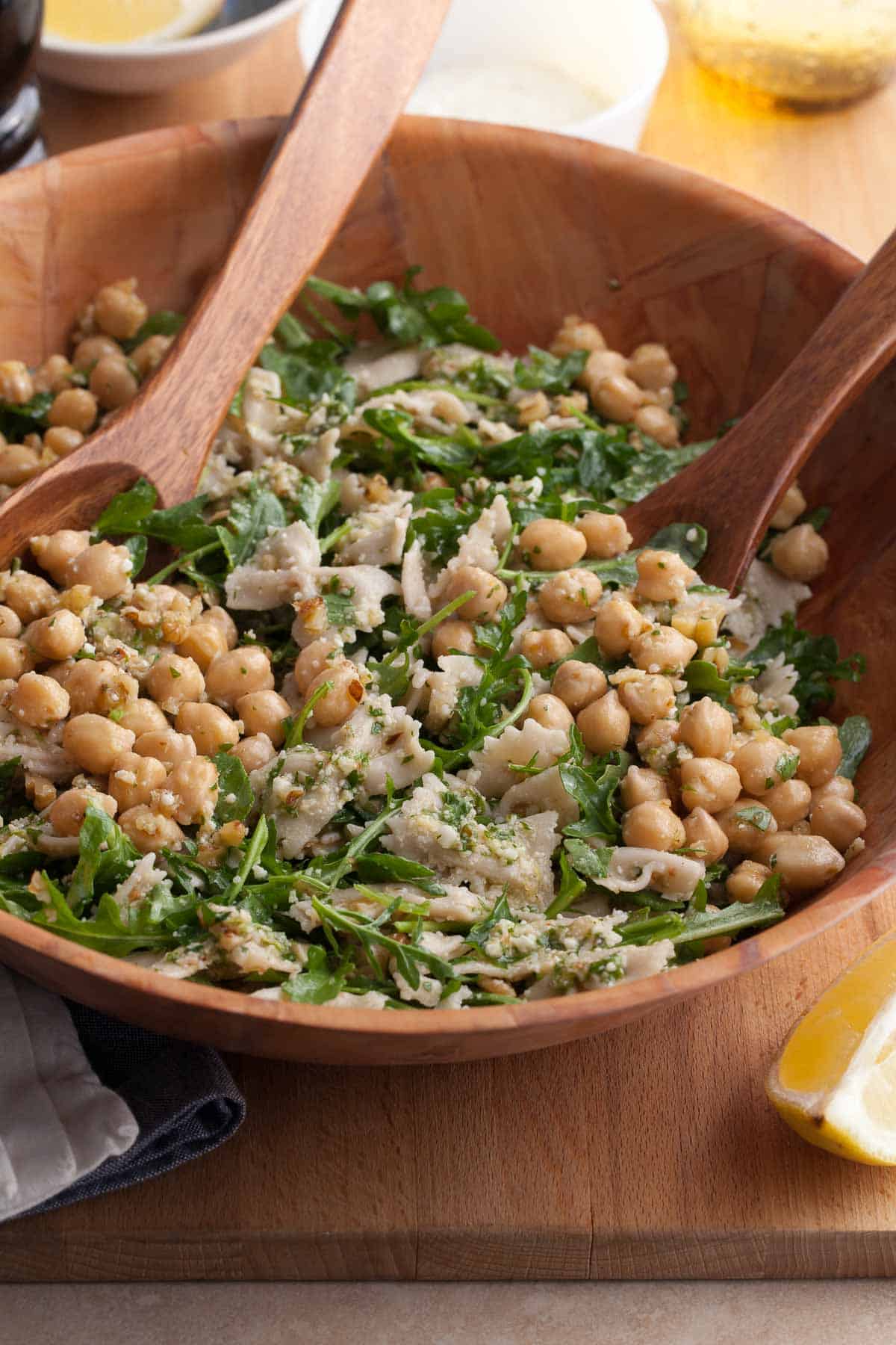 bright, easy pasta salad with chickpeas, arugula, and a lemon dressing in bowl