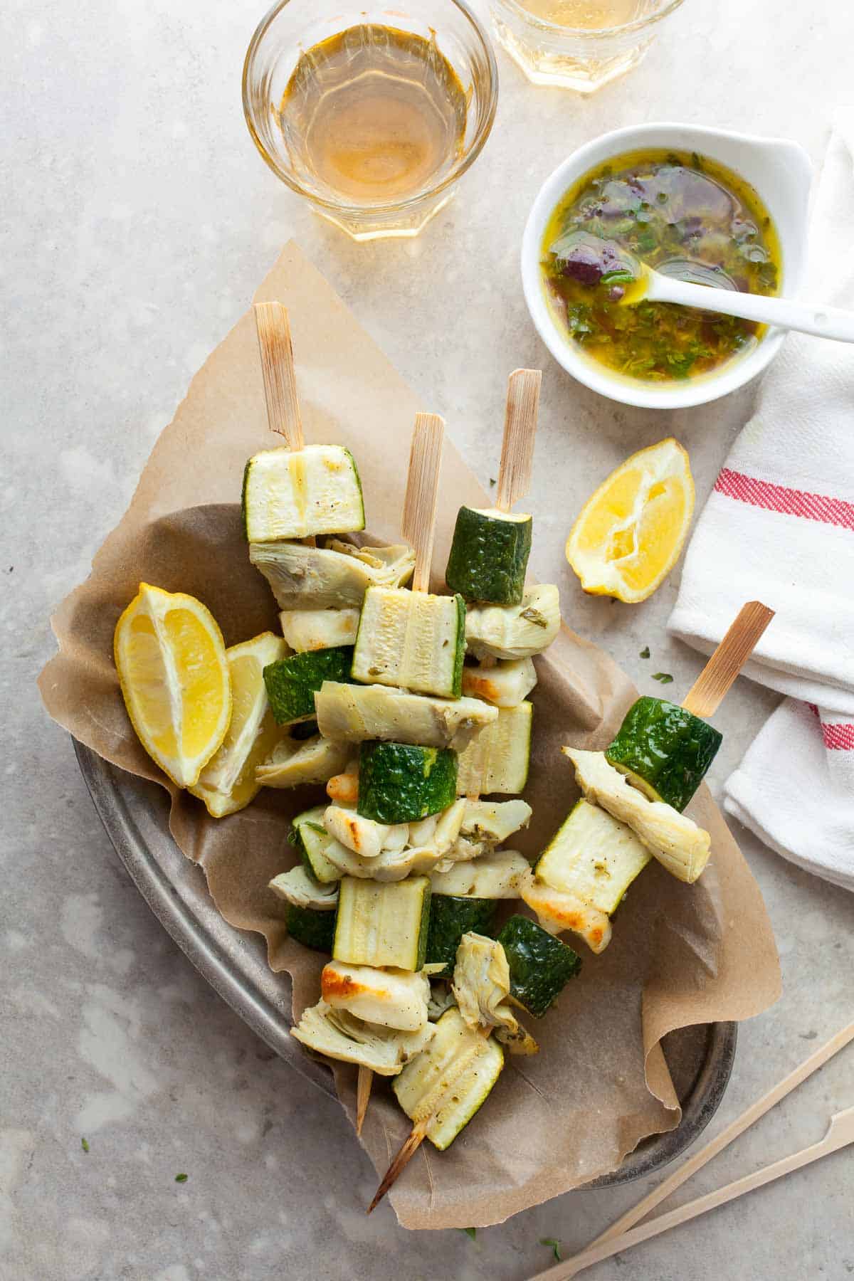 Mediterranean vegetable skewers with halloumi garnished with parsley and lemon