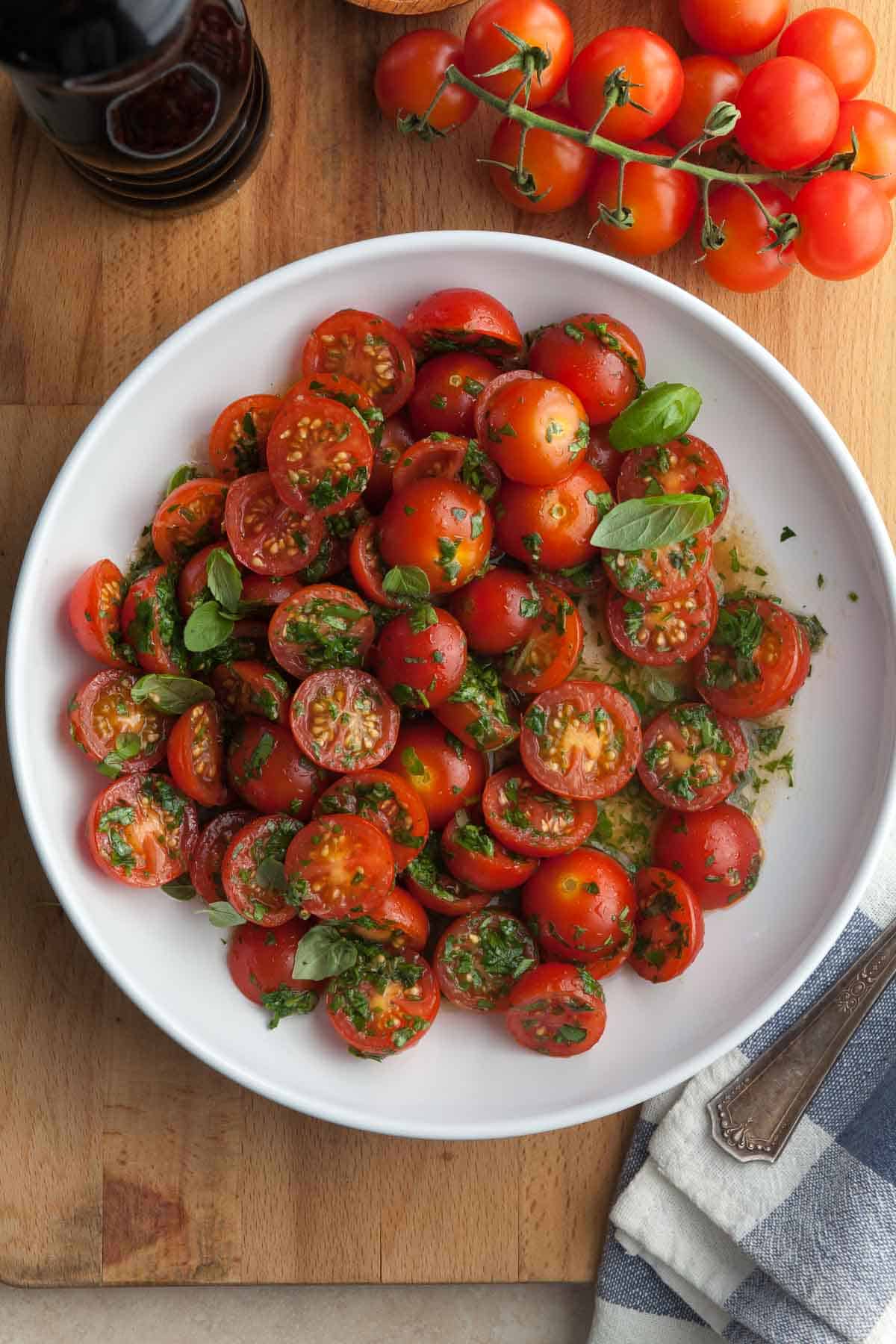 Marinated Tomatoes (Easy Cherry Tomato Salad) on plate with fresh herbs