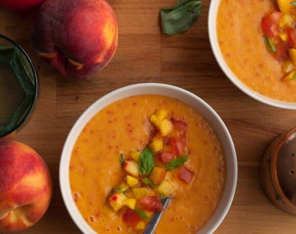 chilled peach tomato soup with fresh basil served in bowls