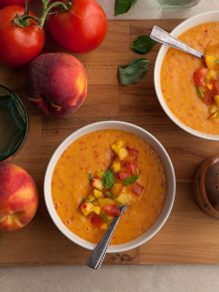 chilled peach tomato soup with fresh basil served in bowls