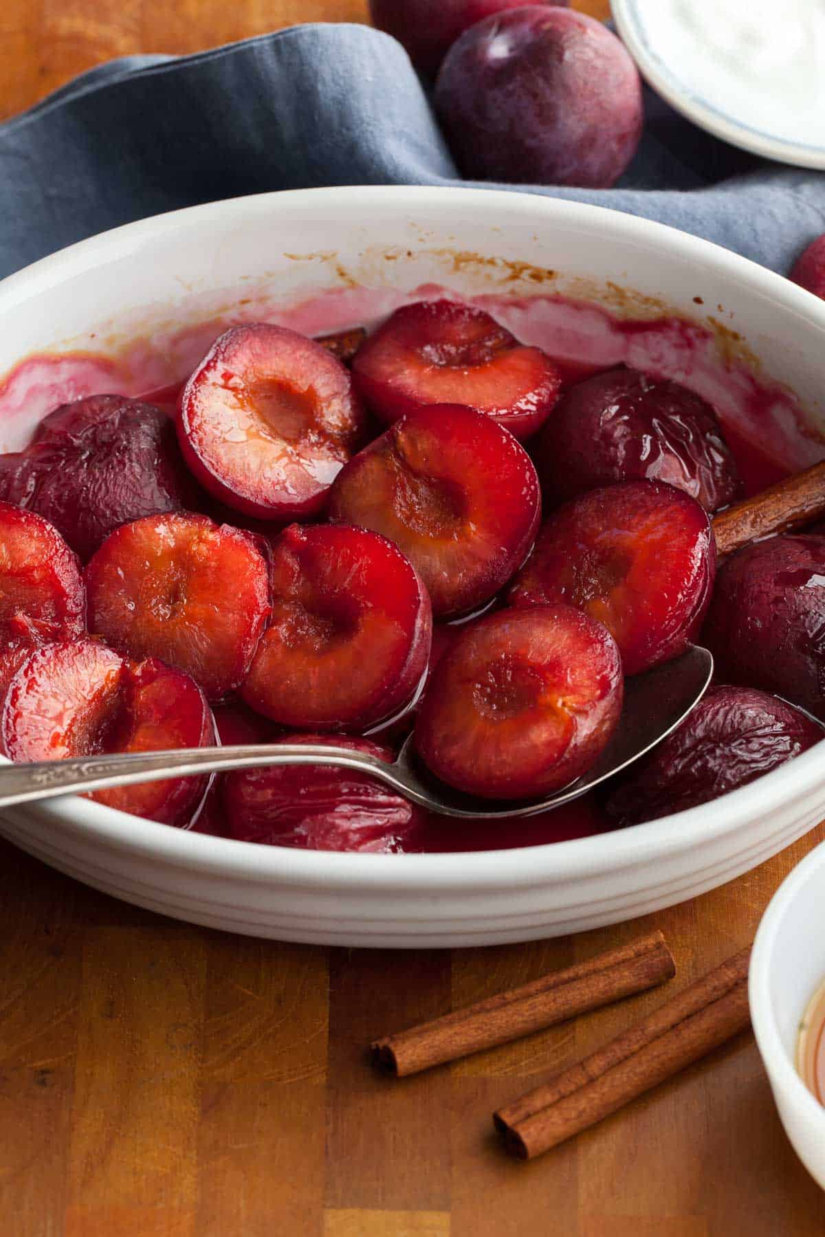 Maple or Honey Roasted Plums in dish with spoon