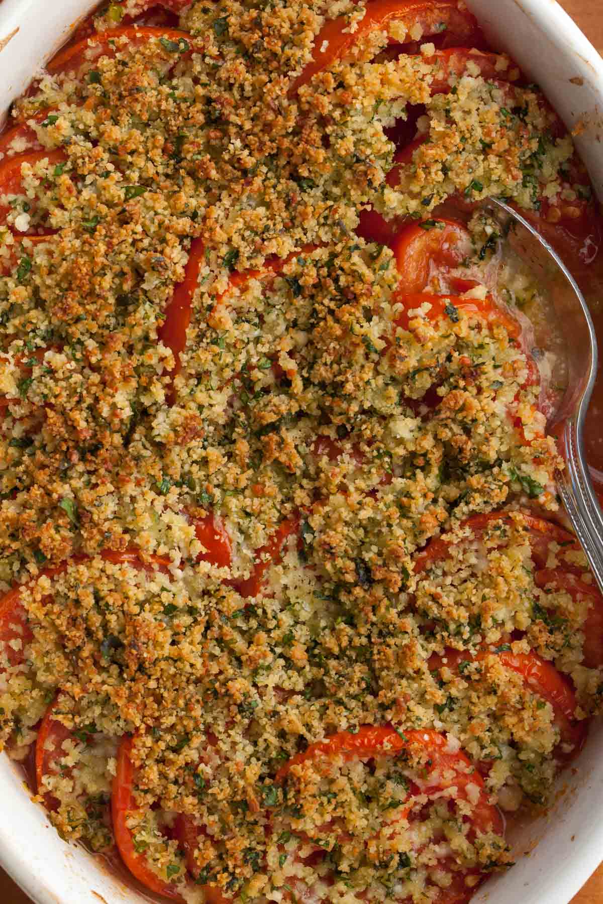 Tomato Gratin topped with cheese and herbs close up