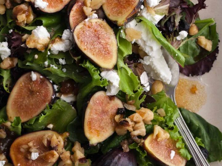 Goat cheese and fig salad close up with toasted walnuts and dried cherries