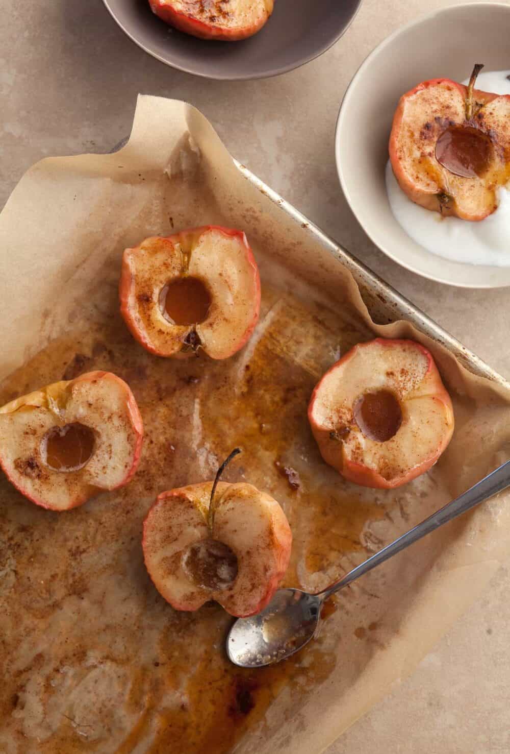 easy roasted apples with cinnamon, butter and maple syrup on sheet pan