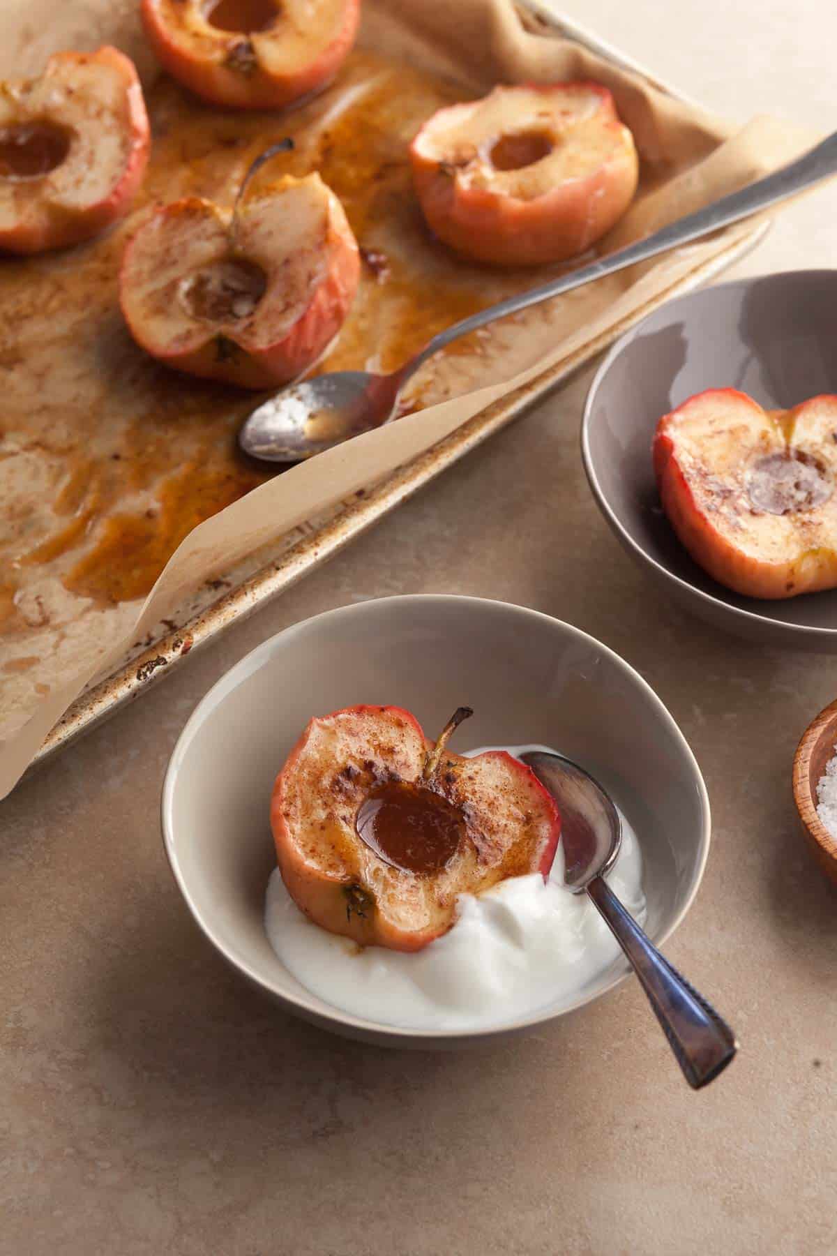 roasted apples with cinnamon and maple syrup served with yogurt in bowl