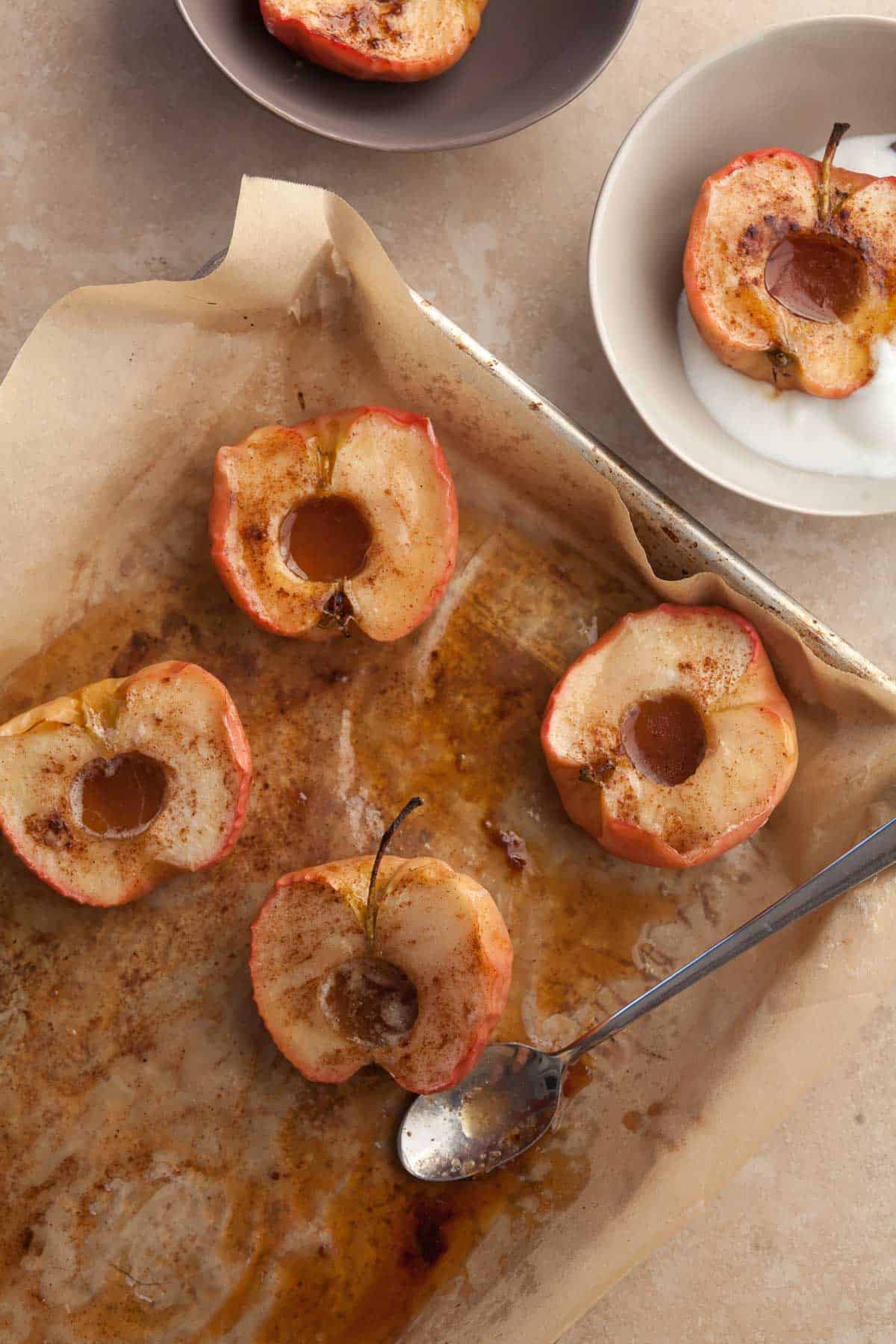easy roasted apples with cinnamon, butter and maple syrup on sheet pan