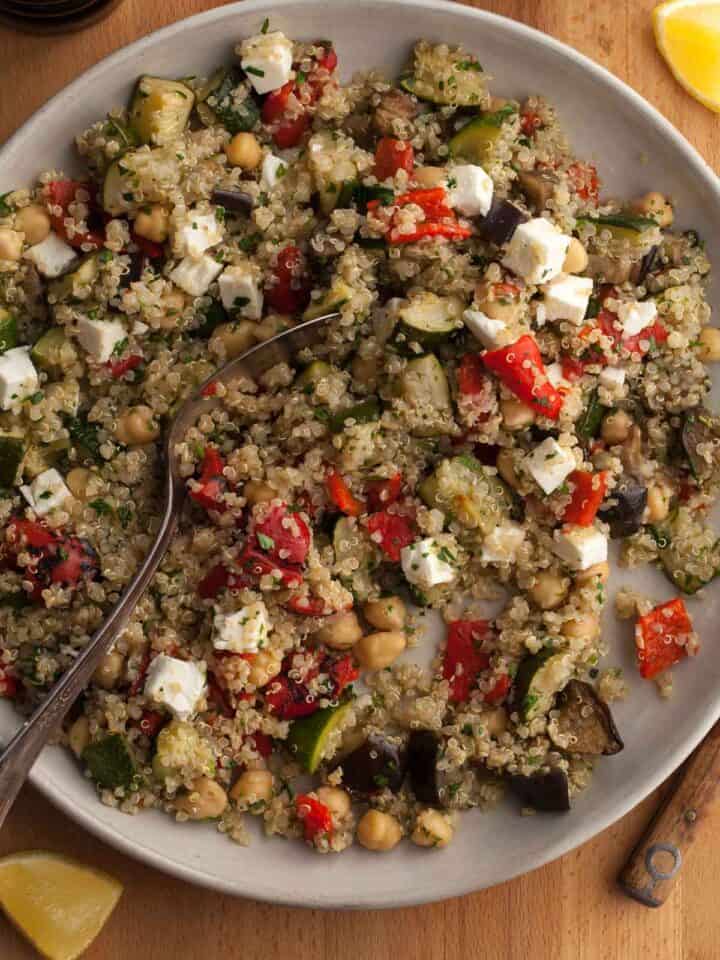 roasted vegetable quinoa salad with roasted zucchini, eggplant and red peppers on plate