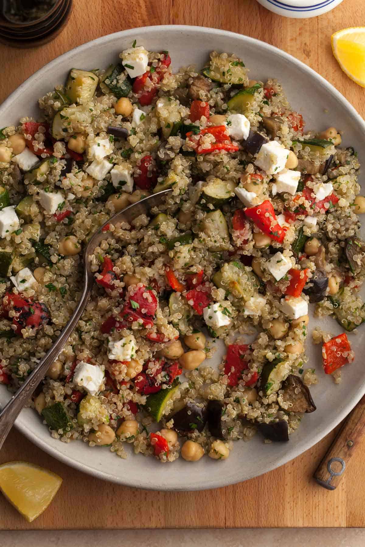 roasted vegetable quinoa salad with roasted zucchini, eggplant and red peppers on plate