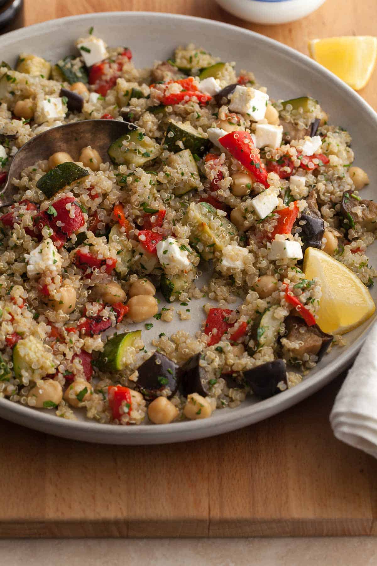 Quinoa salad made with roasted vegetables, chickpeas and feta on plate