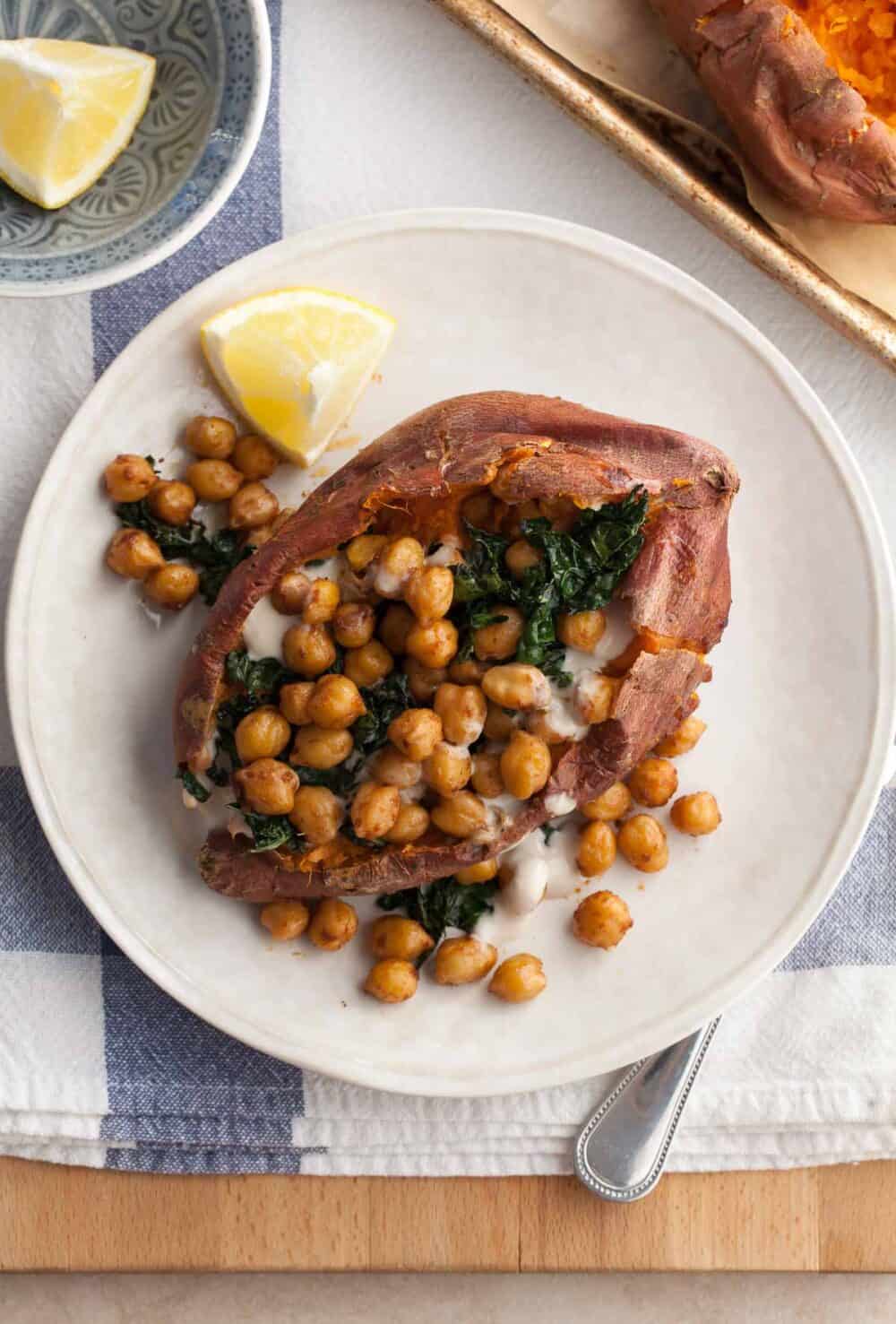 Chickpea Stuffed Sweet Potatoes with Tahini Sauce and Kale on Plate