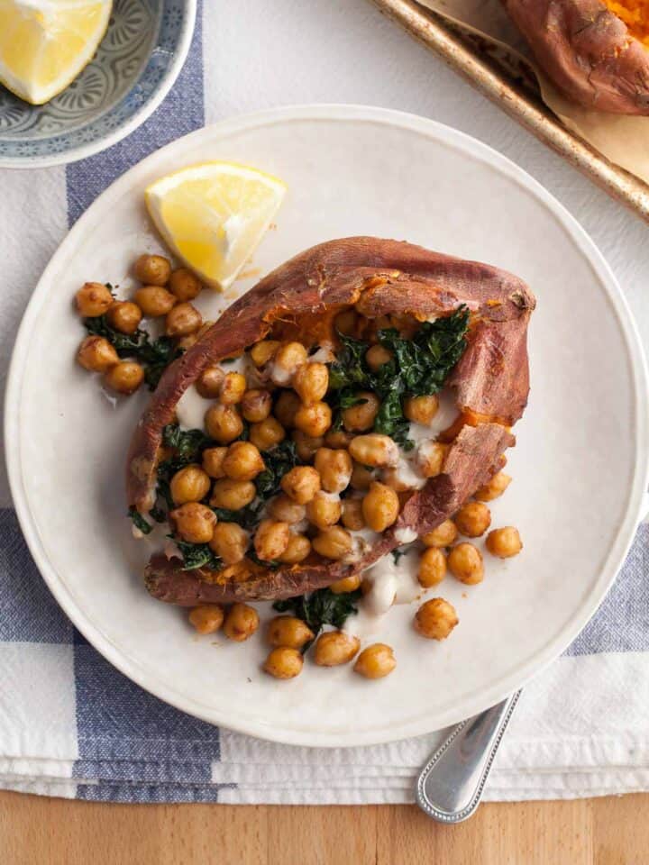 Chickpea Stuffed Sweet Potatoes with Tahini Sauce and Kale on Plate