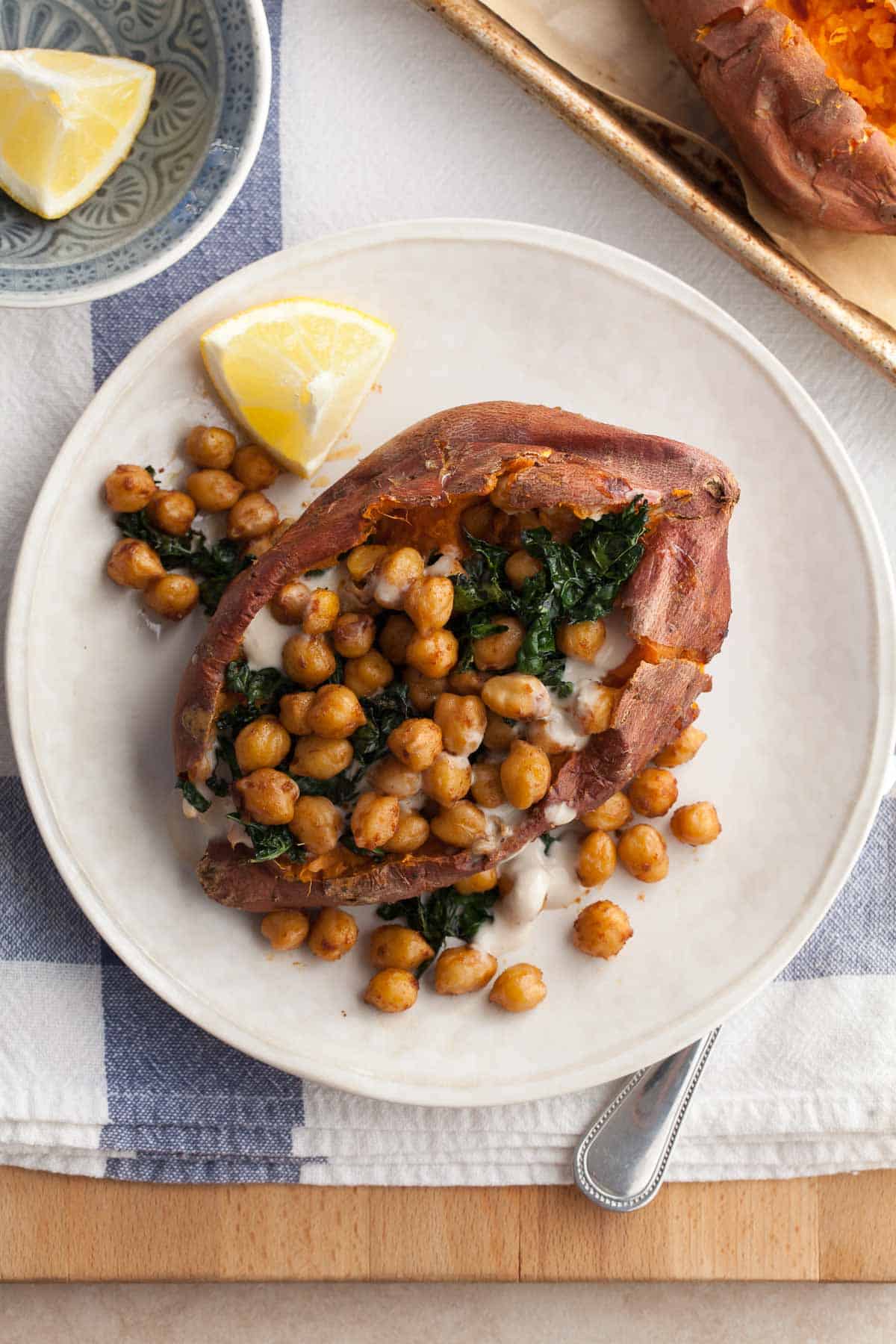 Chickpea Stuffed Sweet Potatoes with Tahini Sauce and Kale on Plate