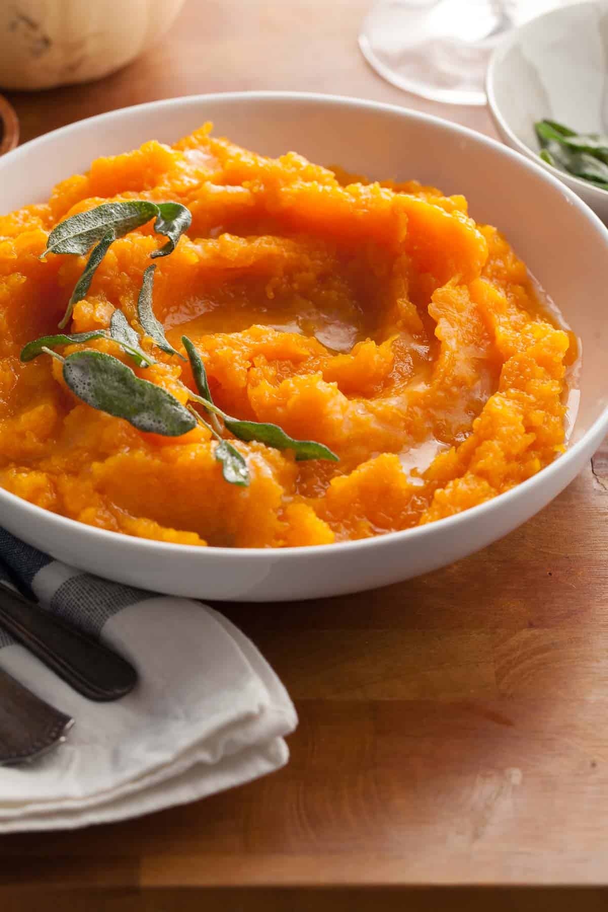 Mashed Butternut Squash Topped With Browned Butter and Sage Side View in Bowl